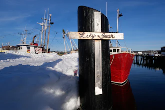 A crucifix, made by a friend of the captain of the fishing boat 'Lily Jean,' is displayed on a pier in Gloucester, Mass., Feb. 2, 2026.