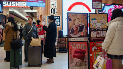 Customers wait outside a Sushiro in Beijing, Jan. 14, 2026.