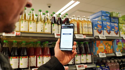 Ian Rosenfeldt, the creator of the 'Made O'Meter' mobile app, demonstrates how shoppers can use the application to identify and boycott American goods in a grocery store in Copenhagen, Jan. 28, 2026.
