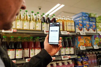 Ian Rosenfeldt, the creator of the 'Made O'Meter' mobile app, demonstrates how shoppers can use the application to identify and boycott American goods in a grocery store in Copenhagen, Jan. 28, 2026.
