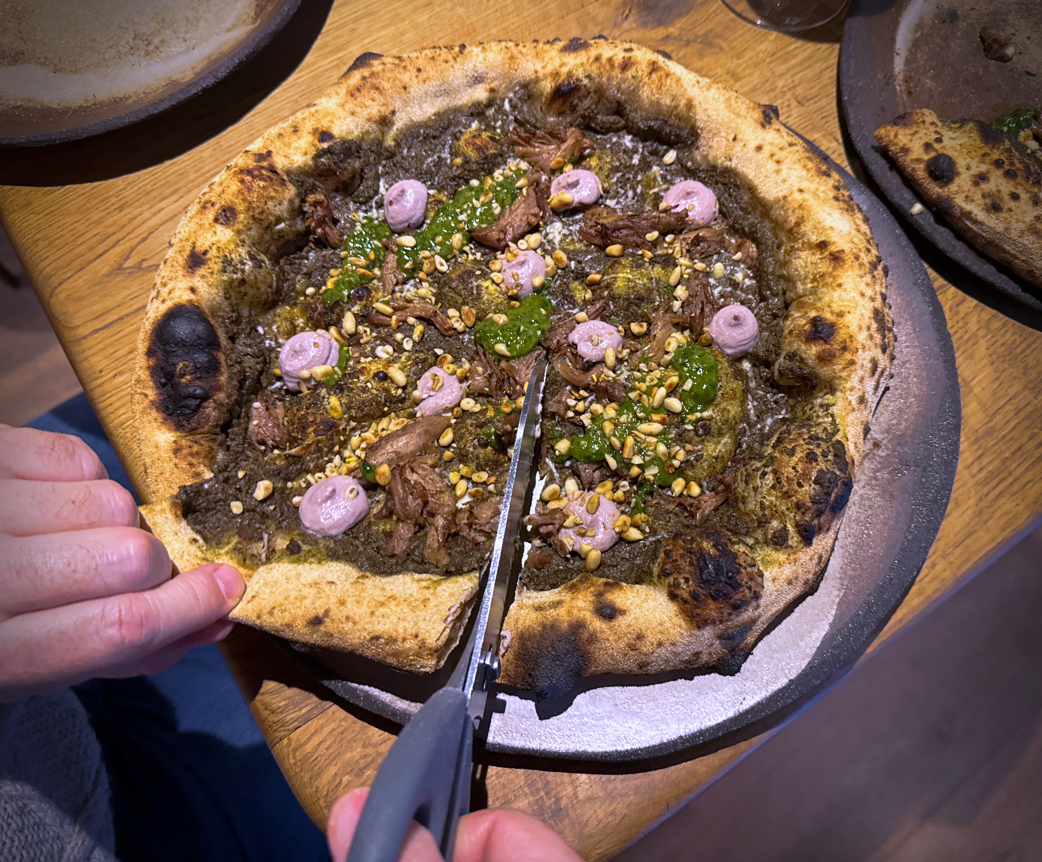 A customer cuts a Roman-era pizza in Budapest, Hungary, Feb. 11, 2026.