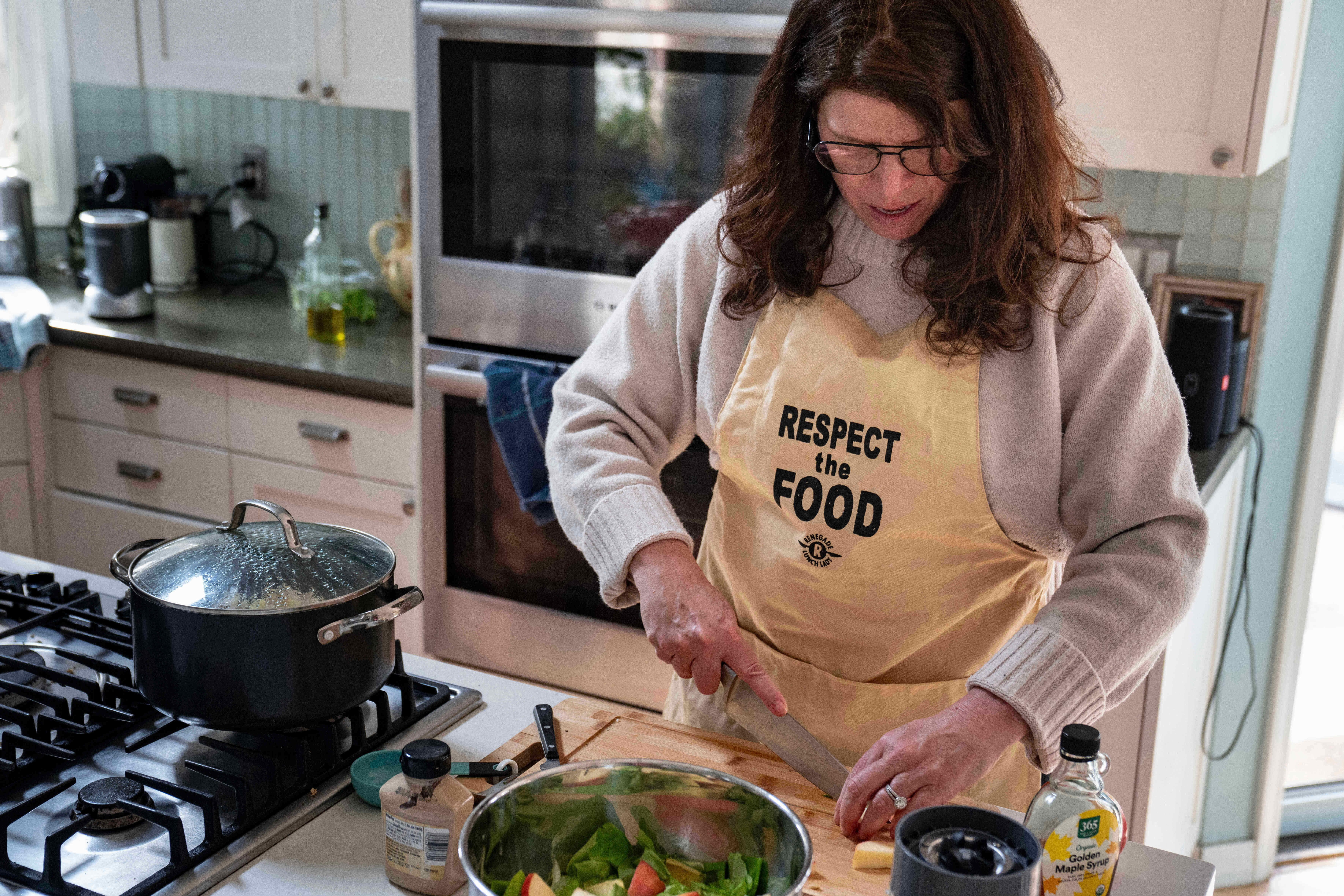 Mara Fleishman, CEO of the Chef Ann Foundation, chops apples for a salad at her home, Feb. 16, 2026, Boulder, Colo.
