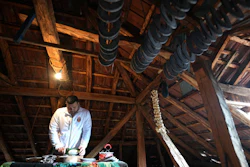 Misa Rajic irons sausage using a glass bottle in the attic of his home in Pirot, Serbia, Feb. 13, 2026.
