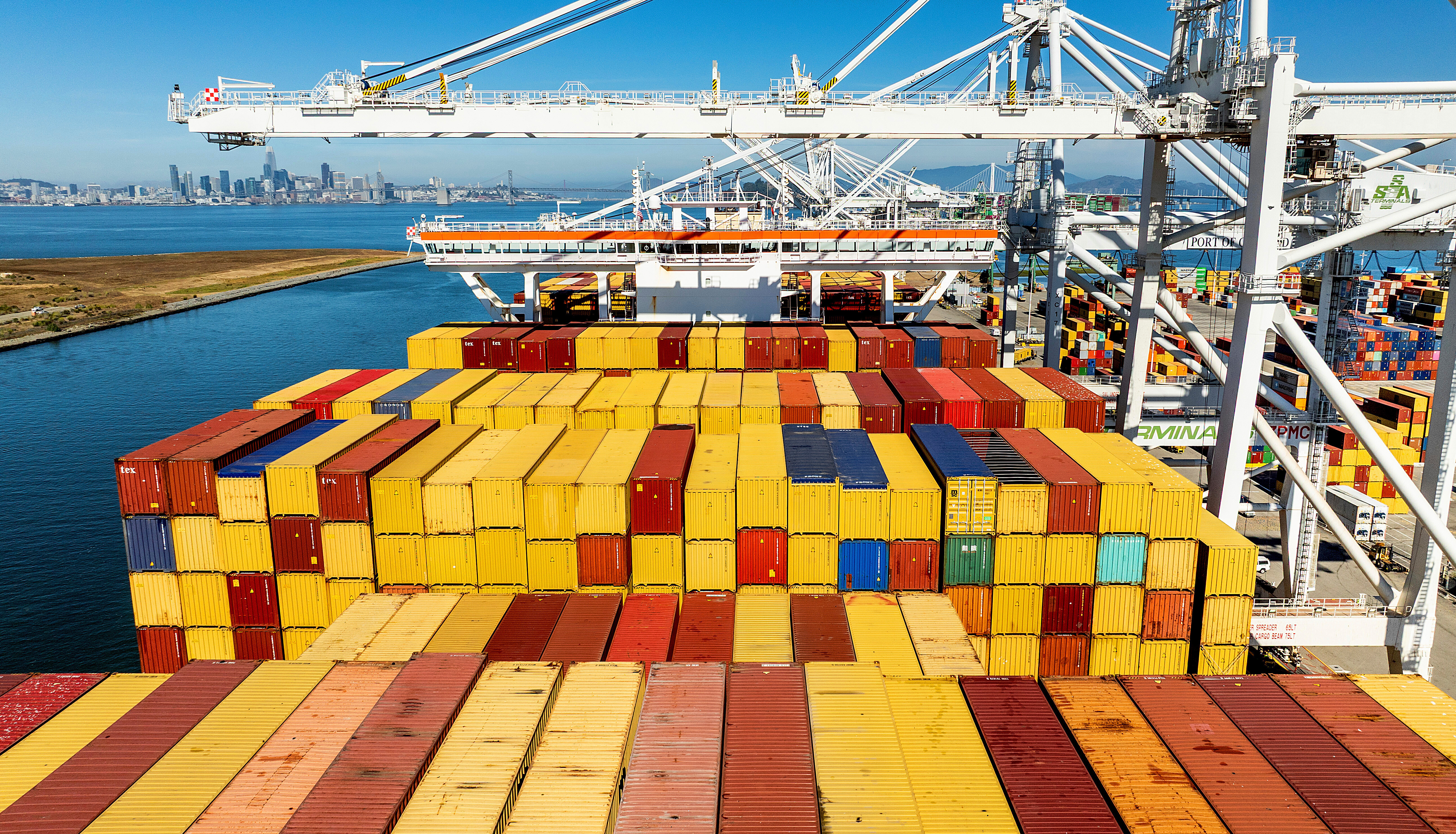 Cargo containers line a ship at the Port of Oakland, Oakland, Calif., Aug. 6, 2025.
