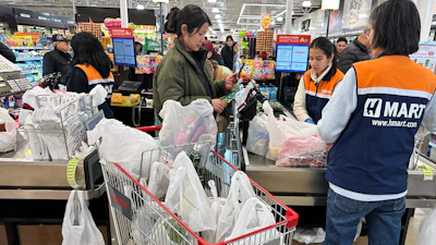 A shopper checks out at a grocery store in Schaumburg, Ill., Feb. 9, 2026.