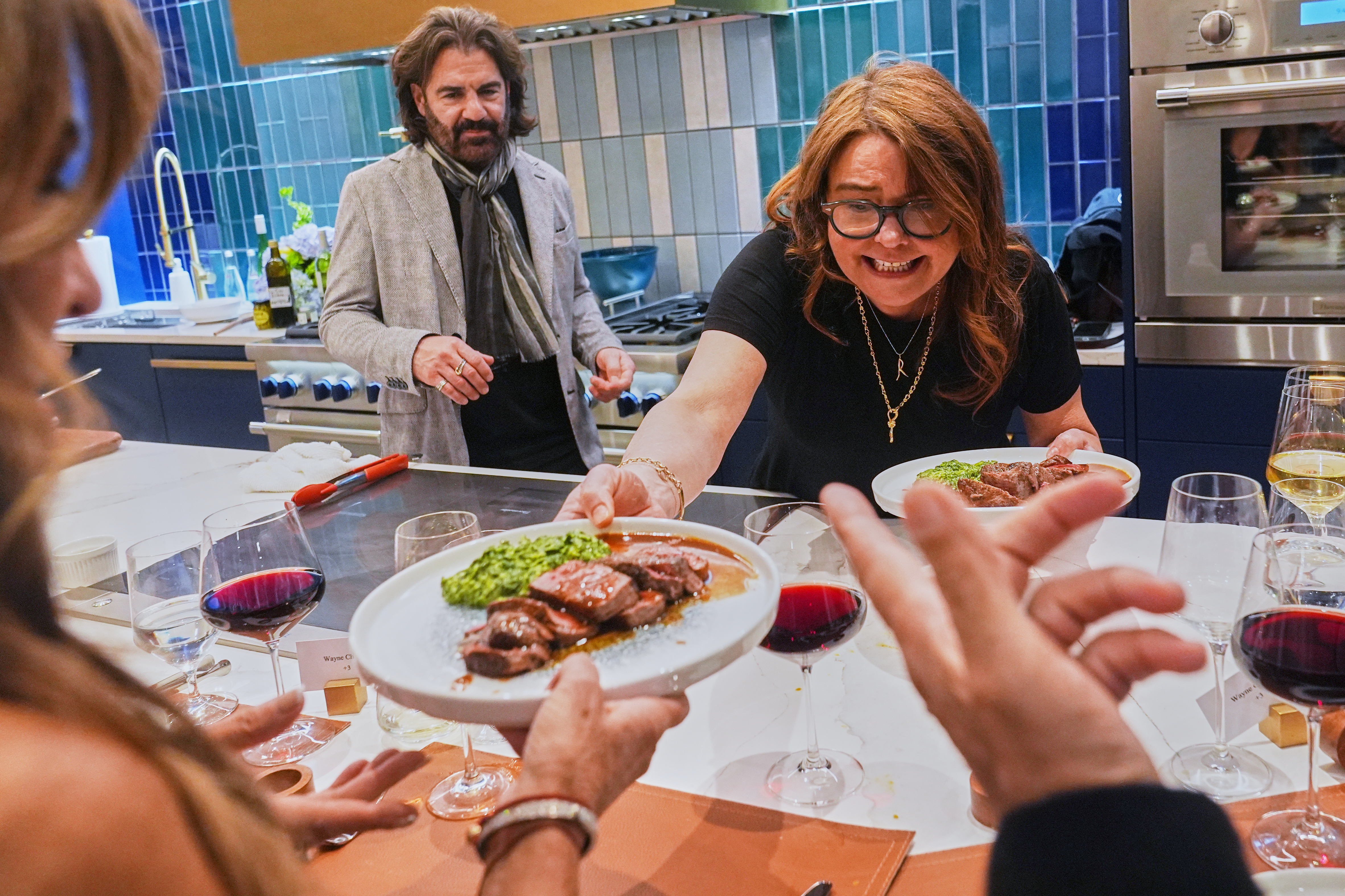 Rachael Ray serves the main course to guests at a private dinner during the South Beach Wine and Food Festival, Feb. 20, 2026, Miami.