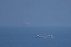 A UAE navy ship patrols the Strait of Hormuz as seen from Mina Al Fajer, United Arab Emirates, March 11, 2026.