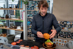 Noma's chef René Redzepi prepares a vegetarian burger in a restaurant, in Copenhagen, Nov. 24, 2024.