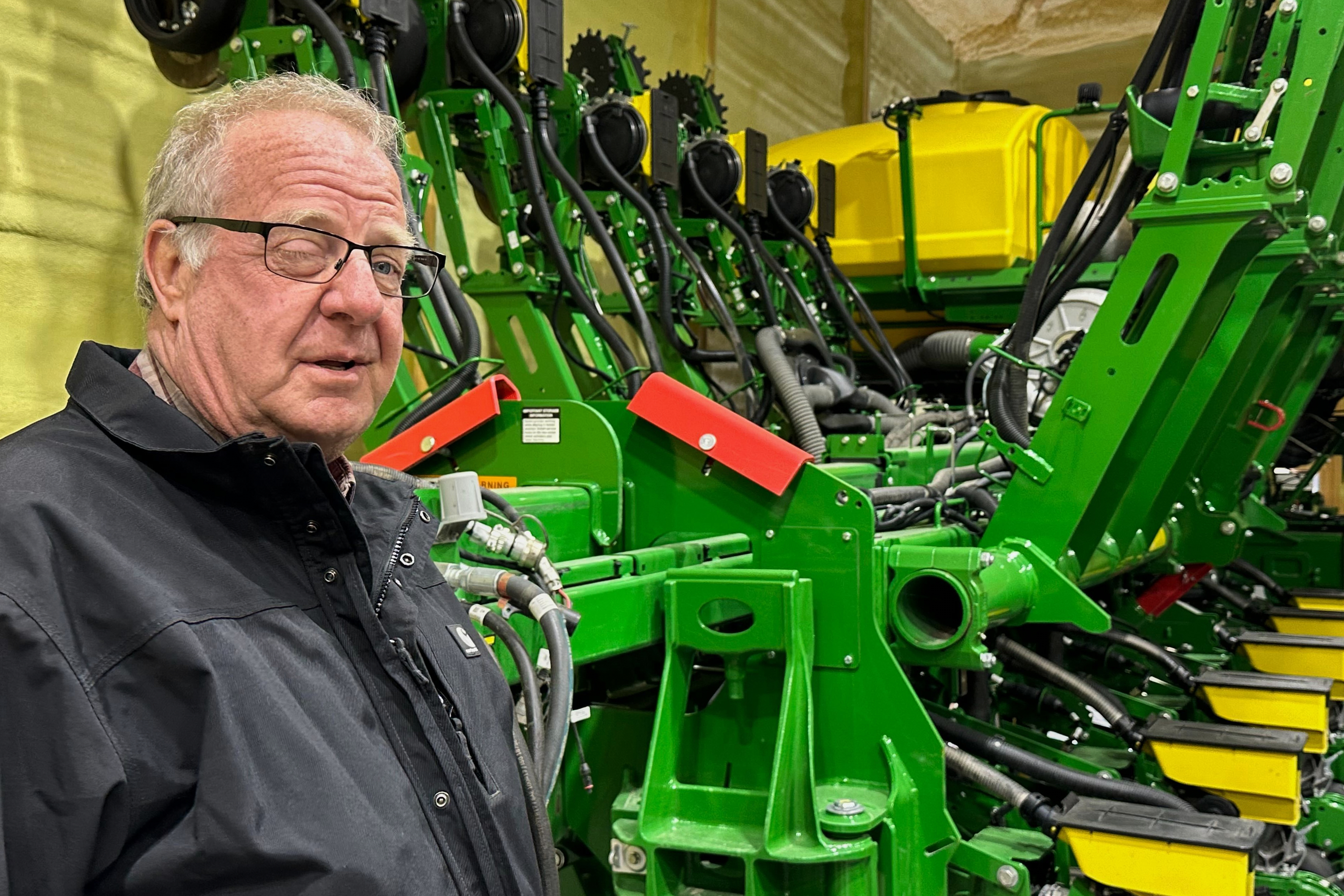 Tom Waters, a seventh-generation farmer, stands next to his planting machinery in Orrick, Mo., March 13, 2026.