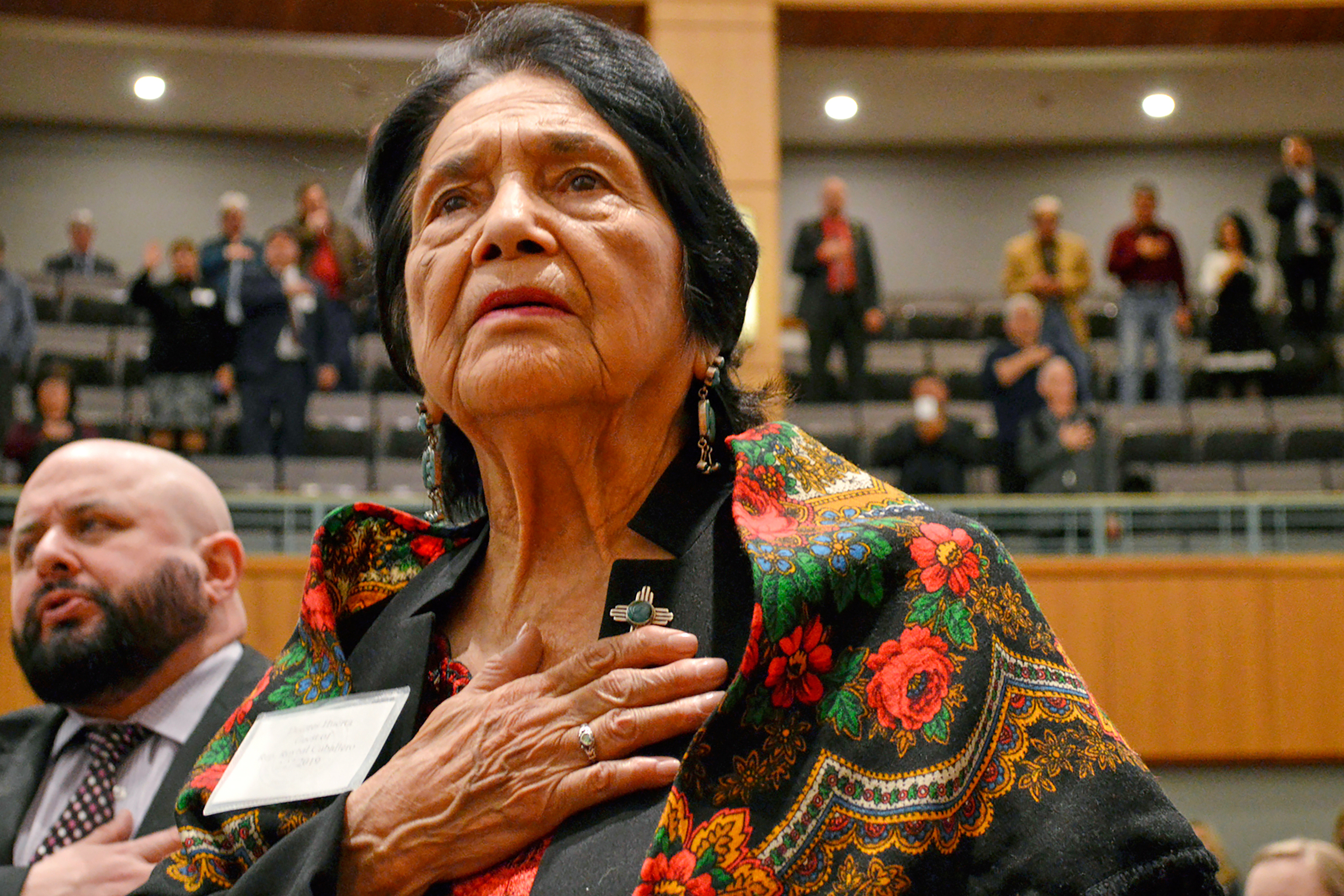 Dolores Huerta stands for the Pledge of Allegiance in Spanish while visiting the New Mexico Statehouse, Santa Fe, Feb. 27, 2019.