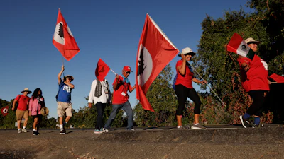 United Farm Workers members march along River Road from Walnut Grove, Calif., to Elk Grove, Calif., Aug. 24, 2022.