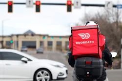 A food delivery motorcycle rider at a traffic light in Lone Tree, Colo., March 30, 2020,