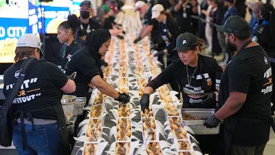 Volunteers assemble cheesesteaks in a Guinness World Record attempt on National Cheesesteak Day at Philadelphia International Airport, March 24, 2026, Philadelphia.
