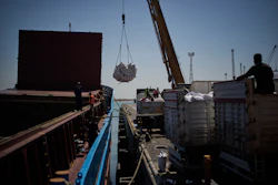 Workers offload cargo of rice from a feeder vessel into trucks at Umm Qasr Port, Iraq, March 27, 2026.