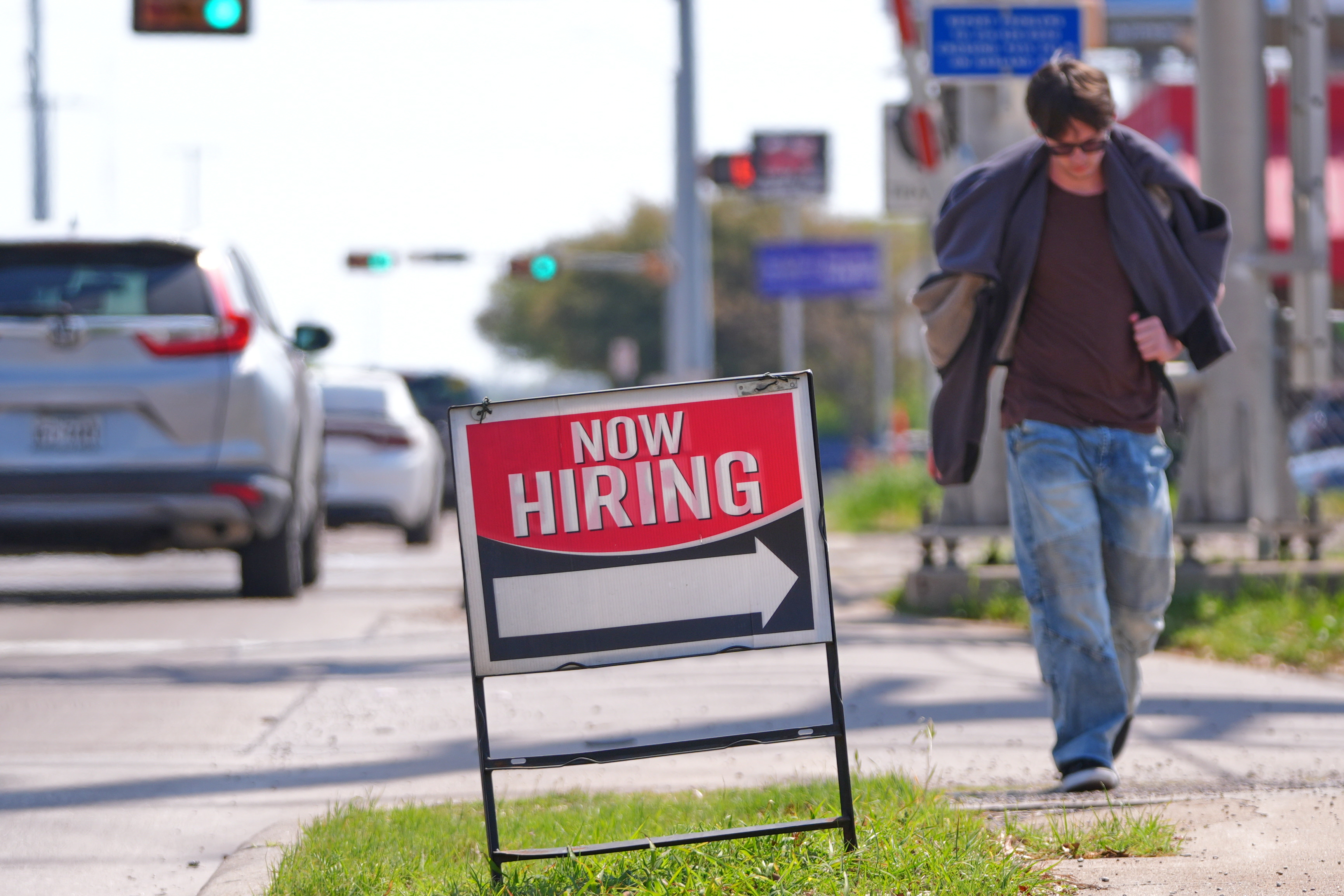 A now hiring sign on the side of the road in Garland, Texas, March 23, 2026.