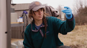 University of Vermont graduate student Delaney Bullock gathers runoff samples in Bridport, Vt., March 12, 2026.