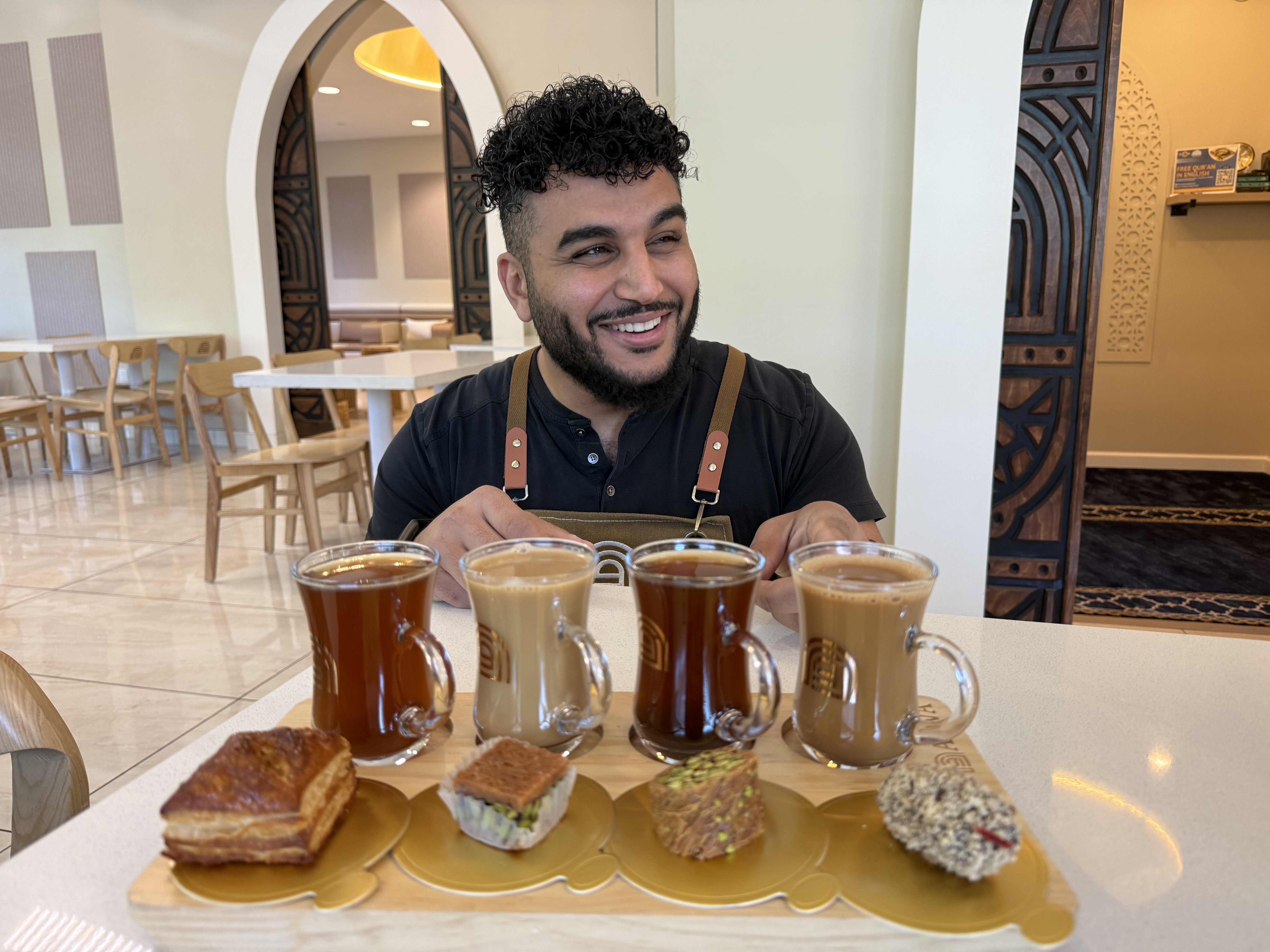 Franchisee Ahmad Badr serves a drink and treat sampler at Arwa Yemeni Coffee in Sunnyvale, Calif., April 6, 2026.