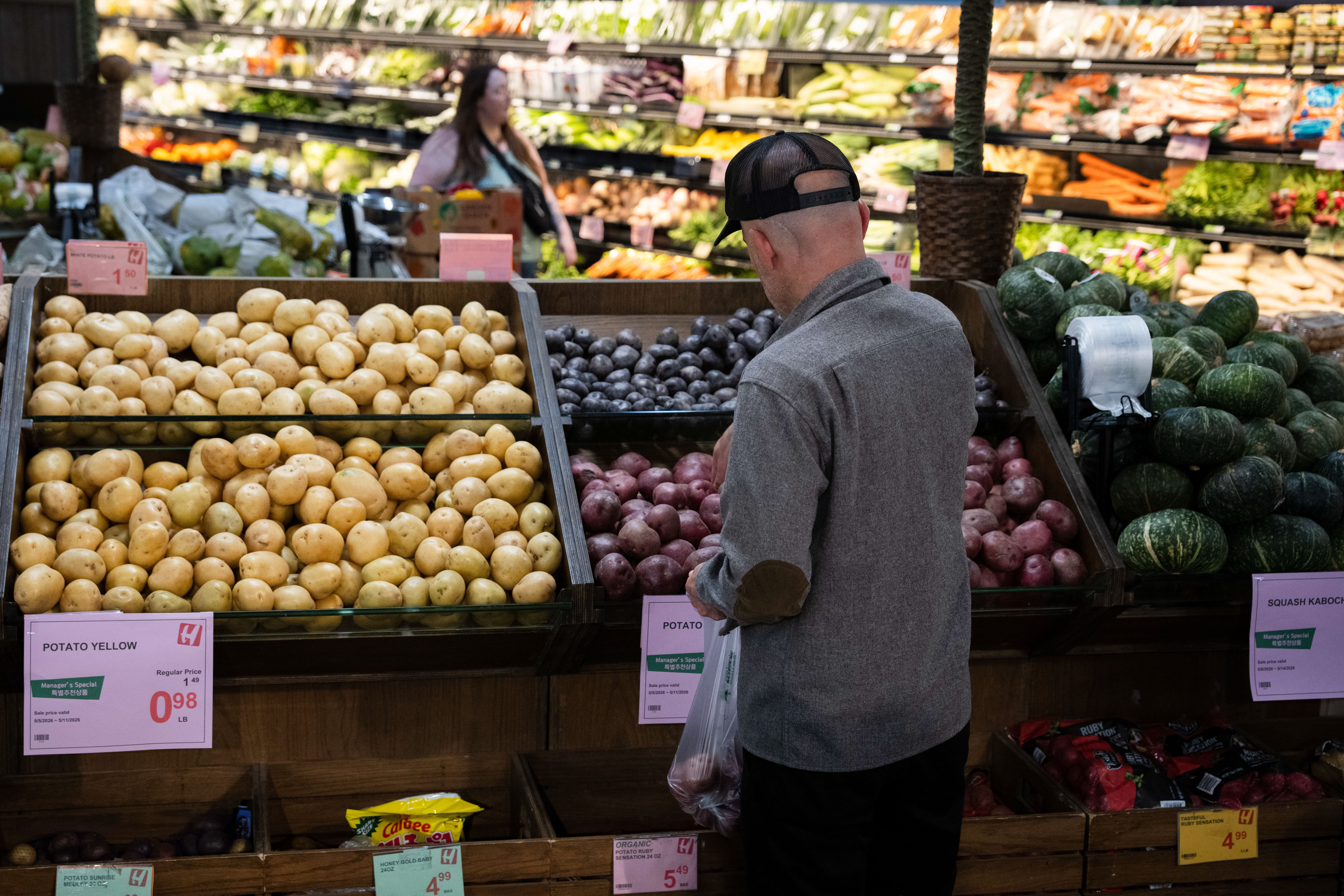 Customers shop in the produce section of a grocery store, May 11, 2026, Portland, Ore.