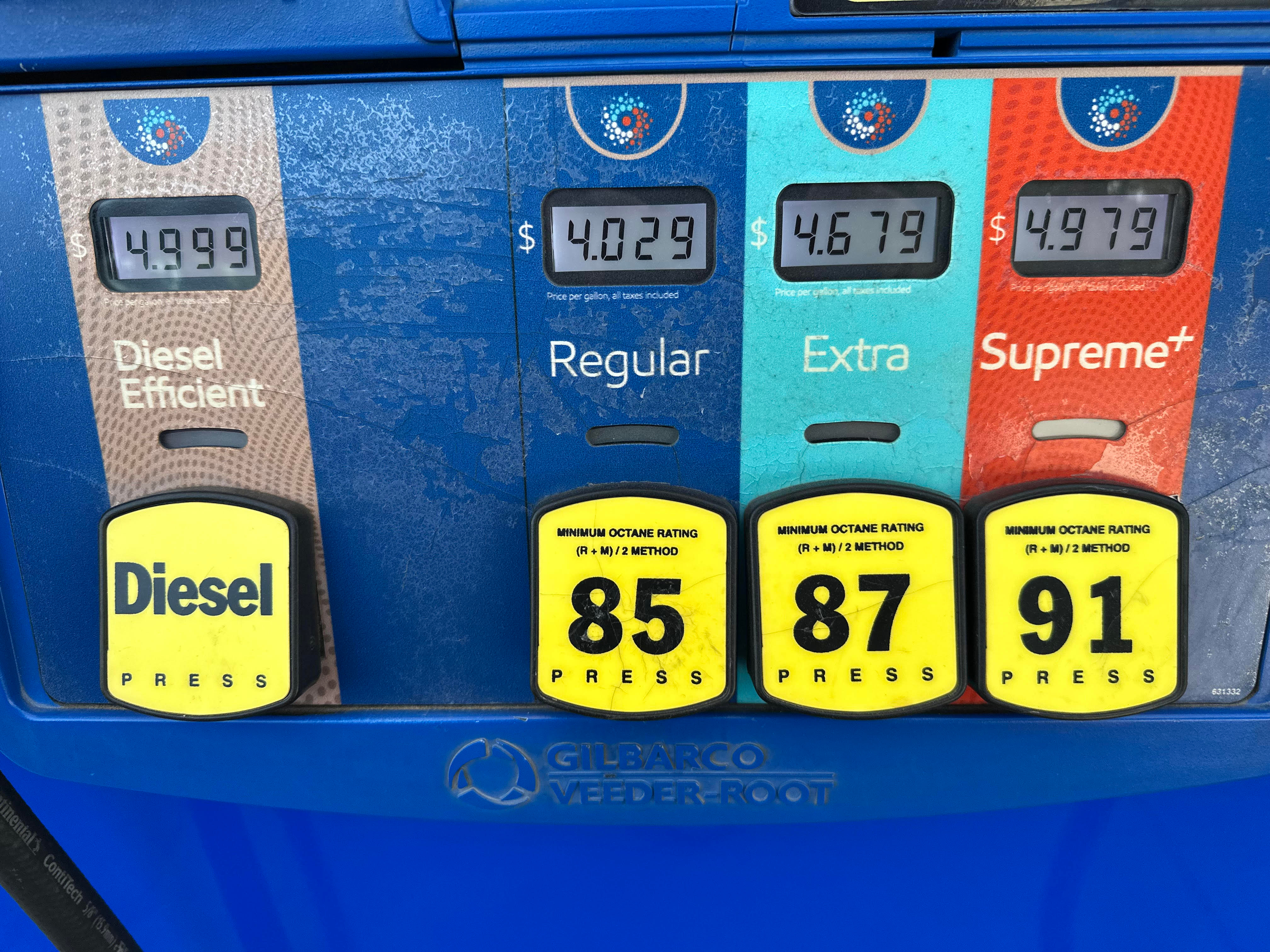The per-gallon price is displayed electronically above the grades of gasoline available from a pump at an Exxon gasoline station in Litttleton, Colo., Tuesday, May 12, 2026.