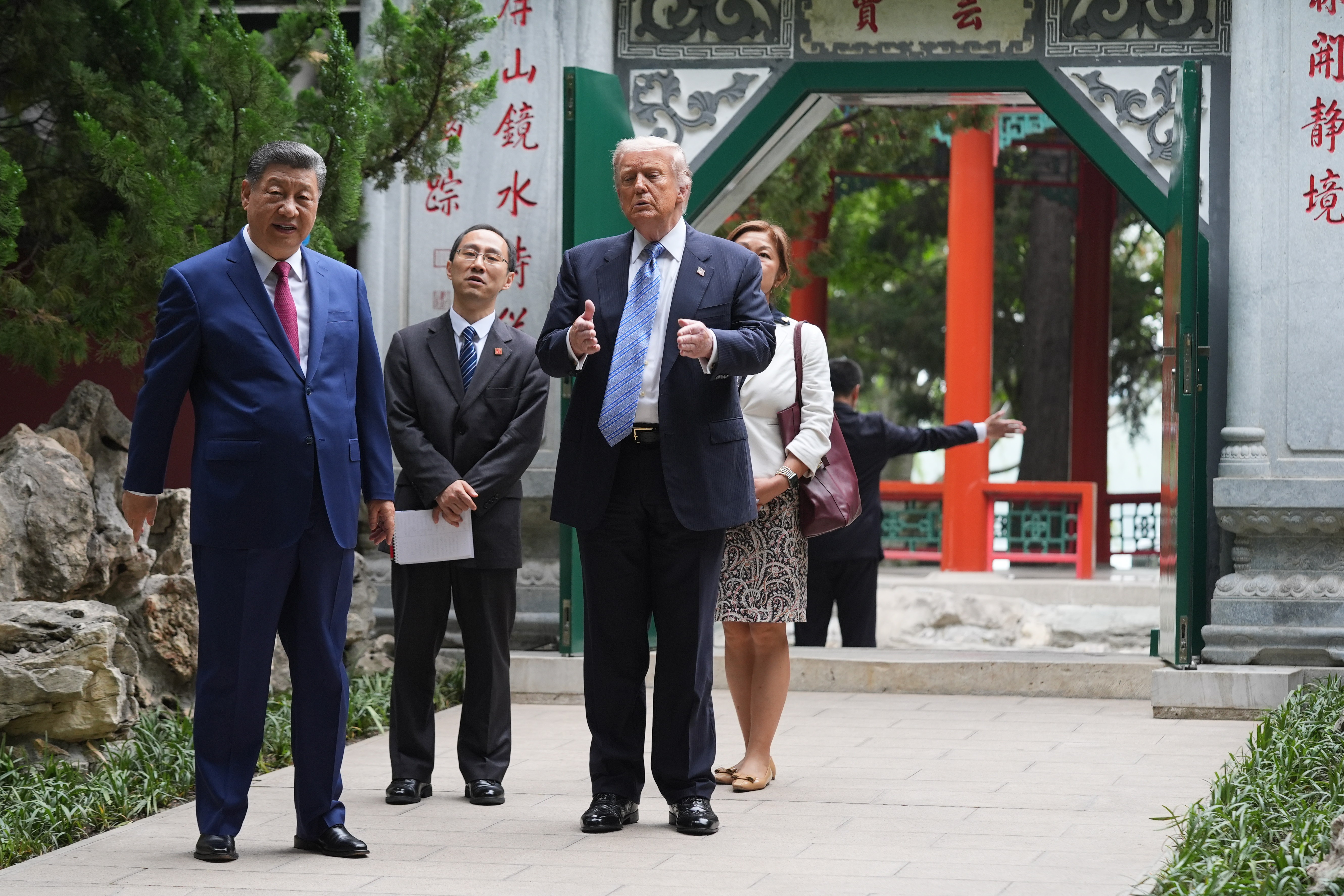 President Donald Trump walks with China's President Xi Jinping at the Zhongnanhai leadership compound, Beijing, May 15, 2026.