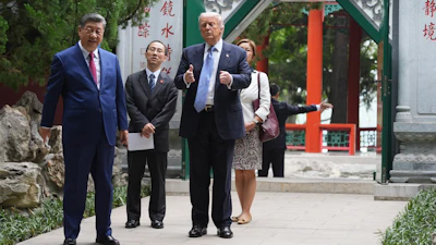 President Donald Trump walks with China's President Xi Jinping at the Zhongnanhai leadership compound, Beijing, May 15, 2026.