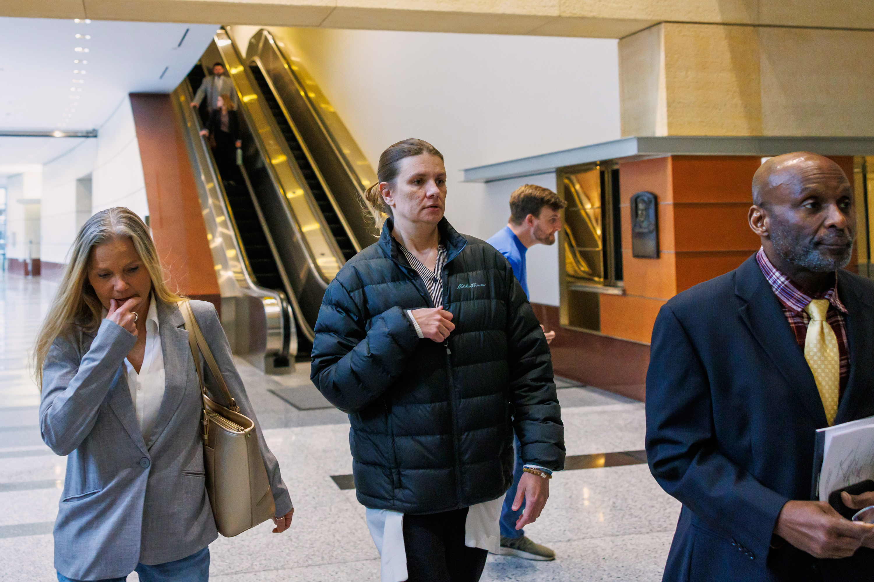 Aimee Bock, founder and executive director of the nonprofit organization Feeding Our Future, arrives at the Minneapolis federal courthouse with her attorney, Ken Udoibok, right, March 19, 2025.