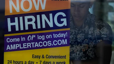 A hiring sign is displayed at a restaurant in Niles, Ill., Thursday, May 14, 2026.