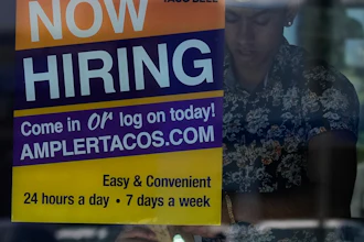 A hiring sign is displayed at a restaurant in Niles, Ill., Thursday, May 14, 2026.