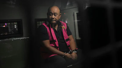 Dadan Hindayana, the former head of Indonesia's National Nutrition Agency, sits inside a detention car at the attorney general's office in Jakarta, June 3, 2026.
