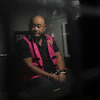Dadan Hindayana, the former head of Indonesia's National Nutrition Agency, sits inside a detention car at the attorney general's office in Jakarta, June 3, 2026.