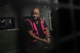 Dadan Hindayana, the former head of Indonesia's National Nutrition Agency, sits inside a detention car at the attorney general's office in Jakarta, June 3, 2026.