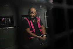 Dadan Hindayana, the former head of Indonesia's National Nutrition Agency, sits inside a detention car at the attorney general's office in Jakarta, June 3, 2026.