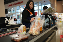 A employee works at a cash register in a grocery store in Schaumburg, Ill., May 14, 2026.