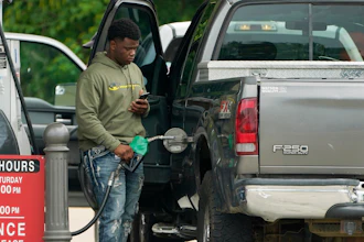 A customer prepares to pump fuel at a Sam's Club, Madison, Miss., May 24, 2022.