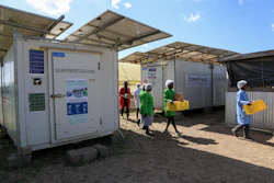 Workers carry fresh herbs from Soko Fresh solar-powered cold rooms at Citadel Agri Merchants, Kitengela, Kenya, May 22, 2026.
