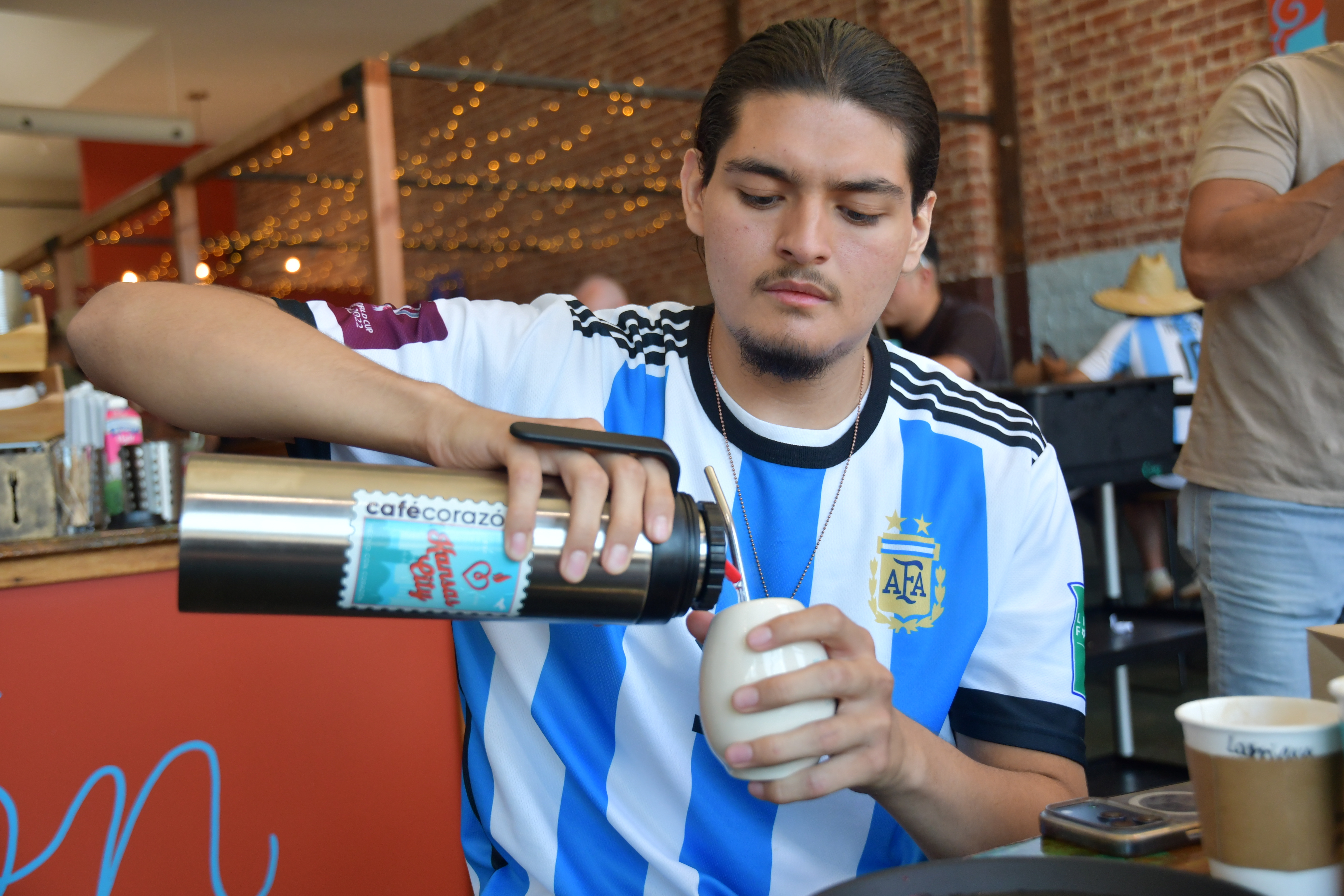 Sebastian Cufre, from Albuquerque, N.M., pours hot water over his cup of yerba mate at Cafe Corazon, Kansas City, Mo., June 15, 2026.