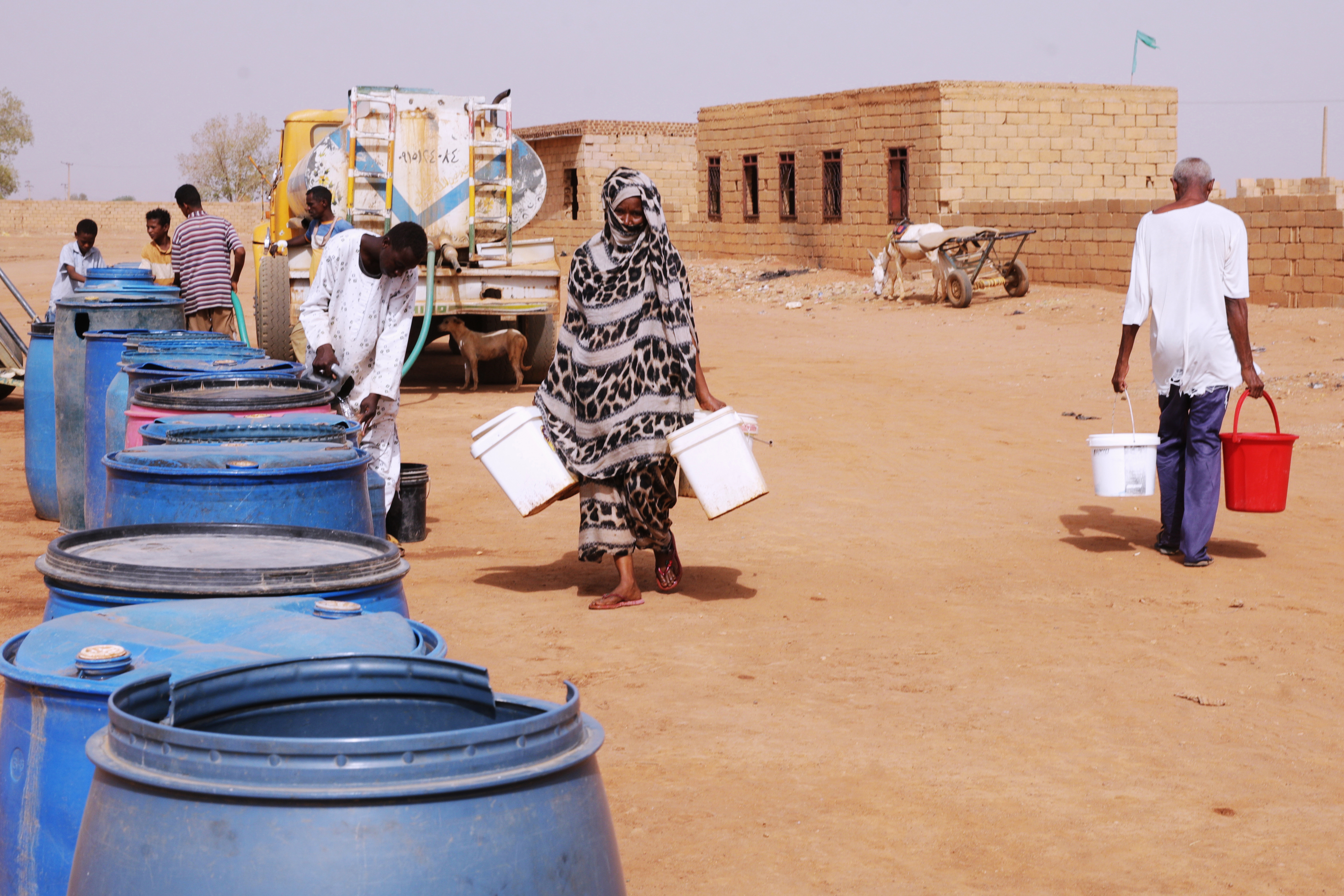 People fill water containers at a free distribution point amid water outages in Khartoum, Sudan, May 18, 2026.