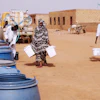 People fill water containers at a free distribution point amid water outages in Khartoum, Sudan, May 18, 2026.