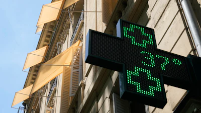 A sign outside a pharmacy displays a temperature of 37 degrees Celsius (98.6 degrees Fahrenheit) in Paris, June 21, 2026.
