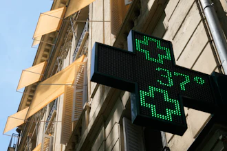 A sign outside a pharmacy displays a temperature of 37 degrees Celsius (98.6 degrees Fahrenheit) in Paris, June 21, 2026.
