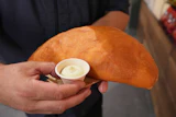 Lazaro Luya, the concession chef at Sol Cubano, displays the 'empanada mundial,' June 21, 2026, Miami Gardens, Fla.
