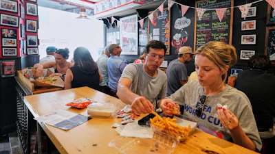 People wearing World Cup shirts taste sandwiches at Pauli's sandwich shop in the North End of Boston, June 24, 2026.