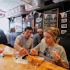 People wearing World Cup shirts taste sandwiches at Pauli's sandwich shop in the North End of Boston, June 24, 2026.