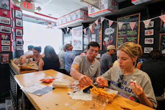 People wearing World Cup shirts taste sandwiches at Pauli's sandwich shop in the North End of Boston, June 24, 2026.
