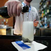 A bartender pours a glass of sparkling wine at the United Club lounge in Minneapolis, June 29, 2026.