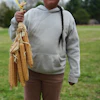 Sowaniu Spears, 11, holds a bundle of Narragansett white flint corn at his grandparents' farm in Hopkinton, R.I., April 21, 2026.