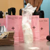Bags with the Molly Tea brand and logo at a shop in Beijing, July 7, 2026.