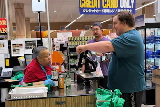 An employee checks a customer's identification card before checking out alcohol at a grocery store in Arlington Heights, Ill., July 6, 2026.