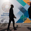 Delegates walk to the entrance of the International Monetary Fund headquarters during the World Bank/IMF Spring Meetings in Washington, April 15, 2026.