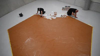 Workers spread peanut butter on a floor at the Museum Boijmans Van Beuningen, Rotterdam, Netherlands, July 3, 2026.
